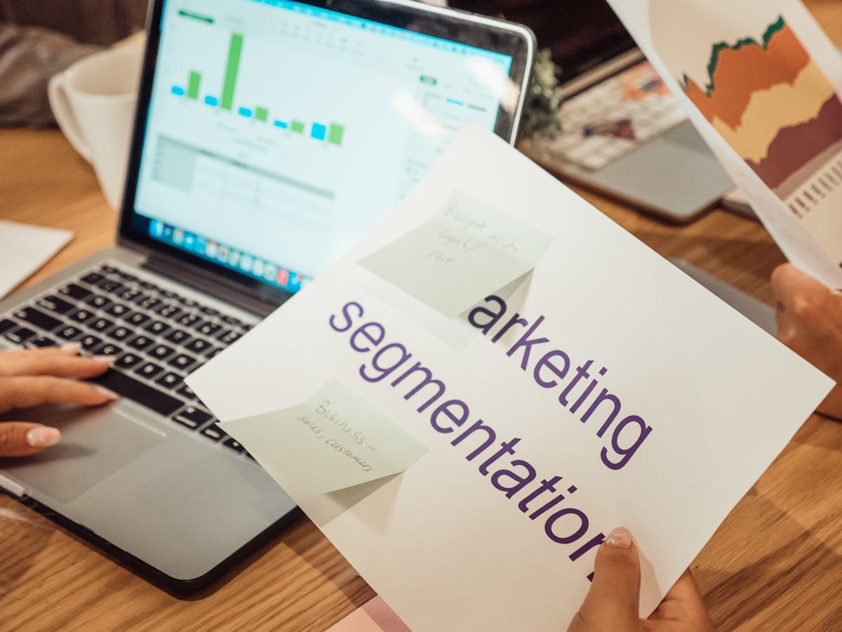 Marketing team analyzing AI visibility strategy and brand performance data on laptop